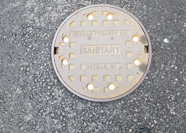 Cast iron sanitary manhole cover