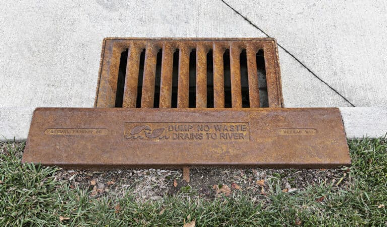 Water inlet frame and grate with Dump No Waste Drains to River text
